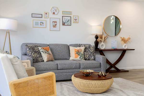 Comfy sofa seating w/ coffee table & stylish console table w/ round mirror