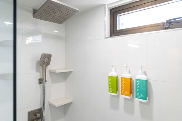 Walk-in shower w/ rainfall head, handheld sprayer & corner shelves