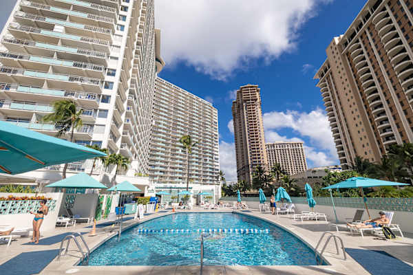 Soak up the sun beside the sparkling, resort-style pool, framed by swaying palms and towering Waikiki skylines for the perfect tropical escape