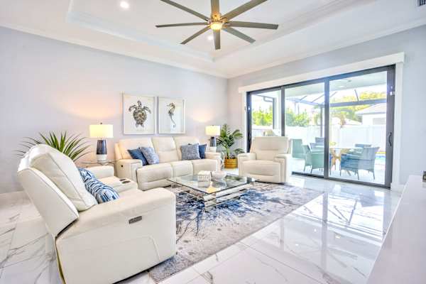 Modern And Bright Living Room With Direct Access To Pool Area, Flat TV, Elegant Decor And Open Layout Filled With Natural Light