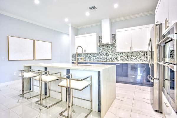 Bright Kitchen With All Necessary Appliances; Central Island With High Bar Stools; Plenty Of Space For Cooking And Gathering