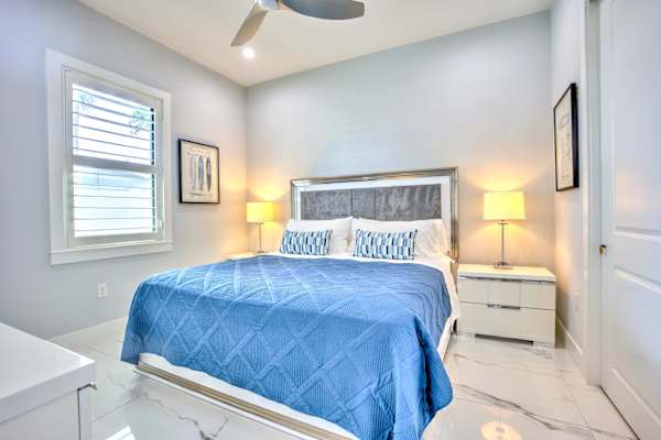 Bright And Modern Bedroom; King Size Bed, Elegant Décor, Natural Light, And Closet Space