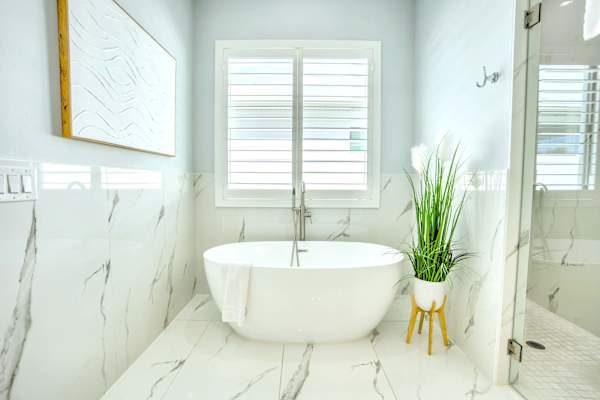 Luxurious, Bright Bathroom; Freestanding Bathtub & Walk-in Shower with Marble Finishes