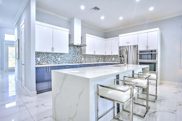 Kitchen With All Necessary Appliances; Central Island With High Bar Stools; Plenty Of Space For Cooking And Gathering