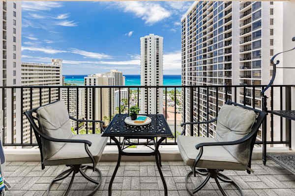 Relax on the balcony with ocean views framed by city skyscrapers.