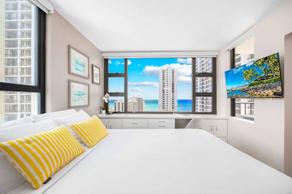 Bright bedroom with ocean views and a modern workspace