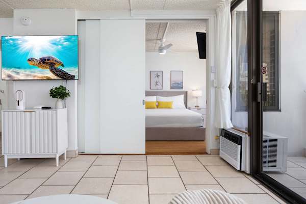 The bedroom is separated from the living area by a sliding door.