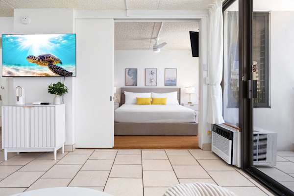 The bedroom is separated from the living area by a sliding door.