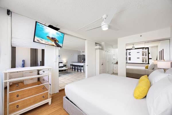 Feel the comfort of your bedroom with a king-size bed, a ceiling fan, a smart TV, and easy access to the bathroom.