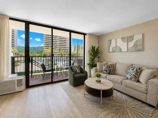 Relax in your living area with a sleeper sofa while enjoying the pool and Diamond head mountain view.