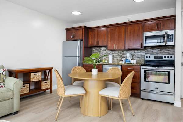 Experience the perfect blend of comfort and convenience in this bright, open-concept living space featuring a modern kitchenette and inviting dining area.