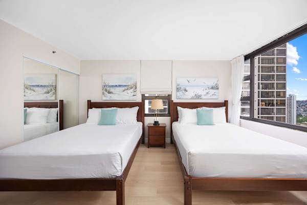 Spacious bedroom featuring two cozy queen beds — perfect for families or groups.