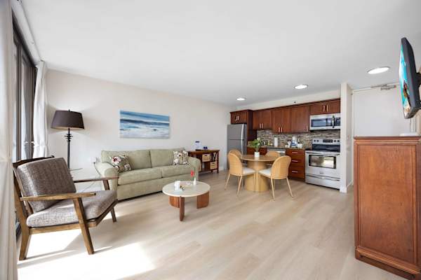 Seamless open-layout living room with abundant natural light, spacious, inviting, and perfectly designed for effortless entertaining and relaxation.