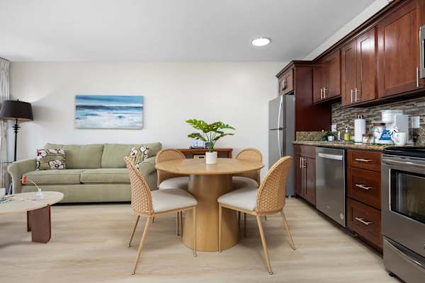 Experience the perfect blend of comfort and convenience in this bright, open-concept living space featuring a modern kitchenette and inviting dining area.