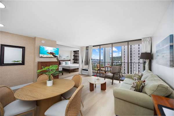 The dining table is conveniently placed beside the open living area, perfect for effortless meals, lively conversation, and seamless entertaining.
