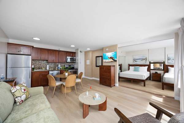This charming condo features a sleeper sofa, TV, dining area for 4, a bedroom with 2 queen beds, and a fully equipped kitchen, perfect for your Hawaiian getaway!