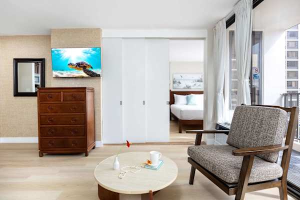 A sliding door separates the bedroom and the living area.