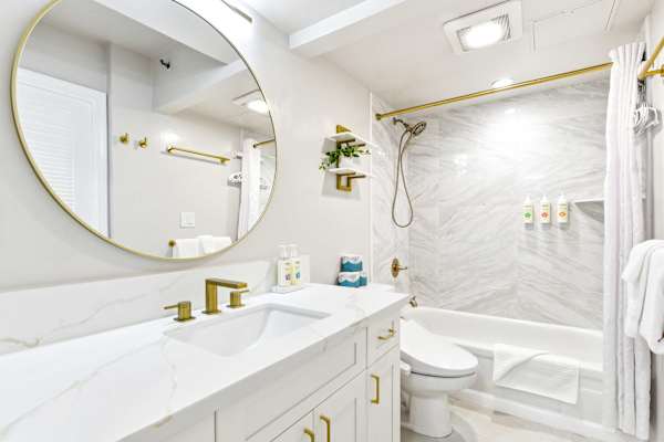 Your full bathroom has a tub/shower combo and a modern toilet with a bidet control panel.