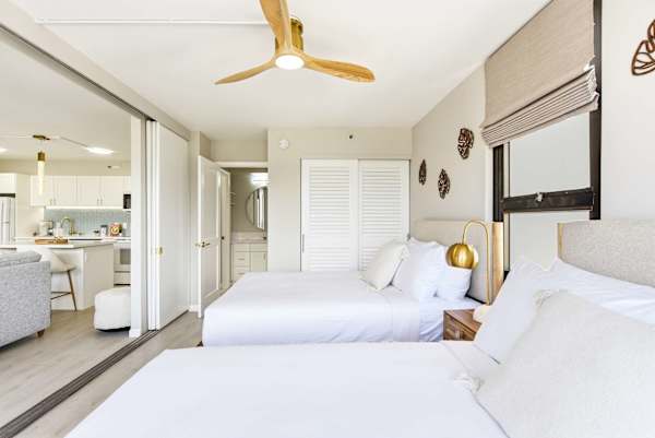 Your bedroom has 2 queen beds, a ceiling fan, a closet, and easy access to the bathroom.