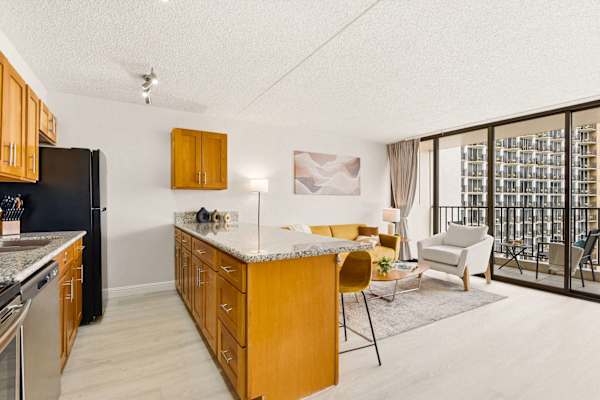 Enjoy effortless open-concept living that seamlessly extends from a spacious kitchen right out to your private balcony view.