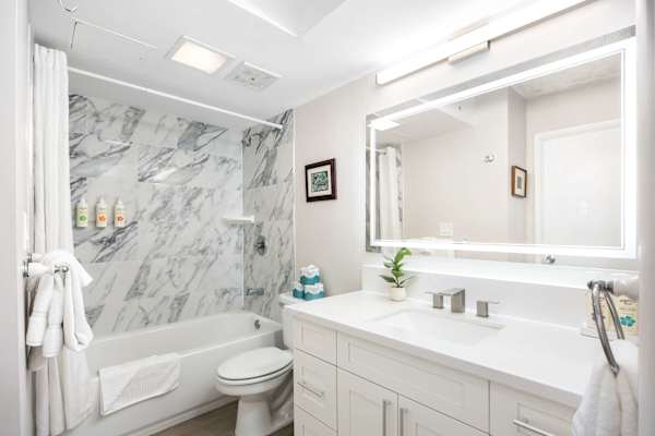 Unwind in a spacious, modern bathroom with sleek finishes and a luxurious bathtub—your private spa-style retreat.