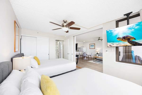 Relax in your bedroom with a queen and a full-size bed while watching your favorite show.
