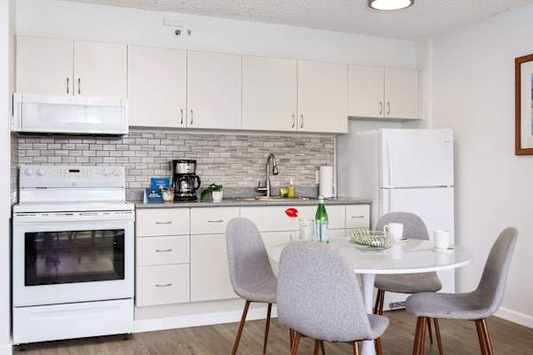 The fully equipped kitchen features a stove, oven, full-size refrigerator, and handy small appliances—everything you need to cook with ease.