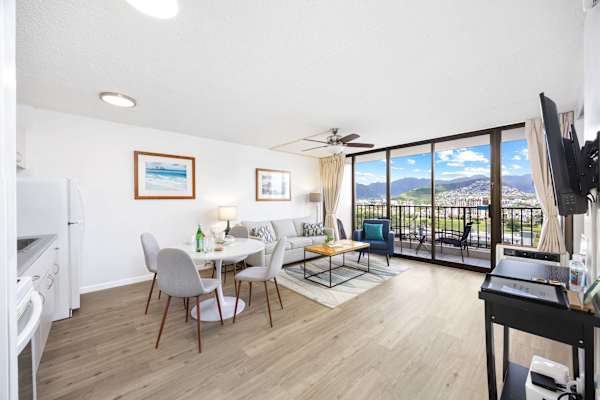 An open layout seamlessly connects the cozy living area with the adjacent dining and kitchen, creating a bright, sociable space perfect for relaxing and entertaining.