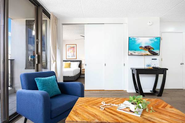 The bedroom sits just across the living room and is separated by a sliding door, offering privacy when you need it and an open, airy flow when you don’t.