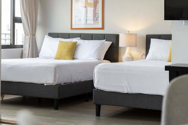 Sink into comfort in our cozy bedroom, featuring a plush queen-size bed and a comfortable full-size bed—perfect for couples, friends, or small families seeking a restful night’s sleep.