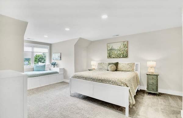 Upper King suite -What sets the two upper king suites apart is not only their stunning lake views & full baths, but also their charming full-size window beds, perfect for parents traveling with children who want the comfort of sleeping together!