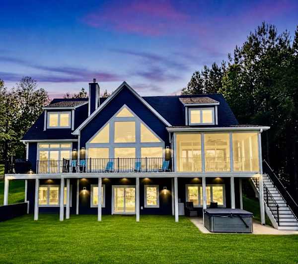 At sunset, Blueberry Bay transforms into a glowing lakeside escape, with three expansive levels illuminated for unforgettable evenings of connection, comfort, and luxury.