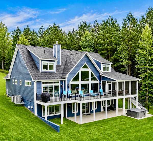 Blueberry Bay is a 5200 sq ft custom built new build designed for families vacationing together or large groups with 6 primary suites, a large great room with a two story wall of windows, hot tub, custom play house, quad bunk room, gourmet kitchen...