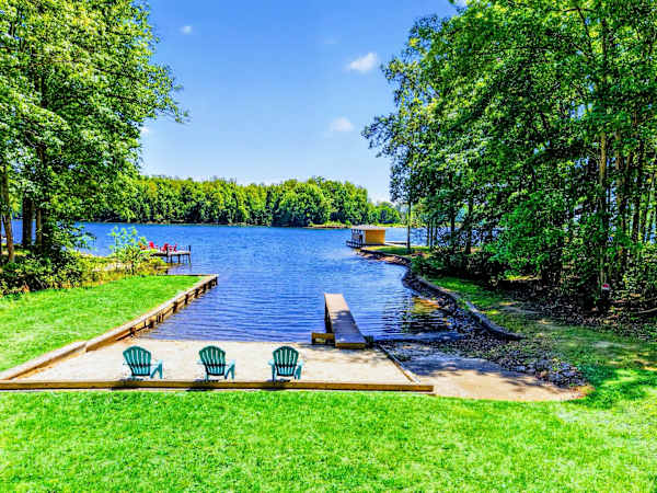 Private Beach - Three Adirondacks waiting on the sand, a dock that stretches into glassy water, this is the photo your group will want.