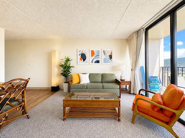 The living area has a sleeper sofa, coffee table, and chair