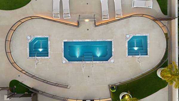 The view of Waikiki Banyan's illuminated spa deck in the evening.