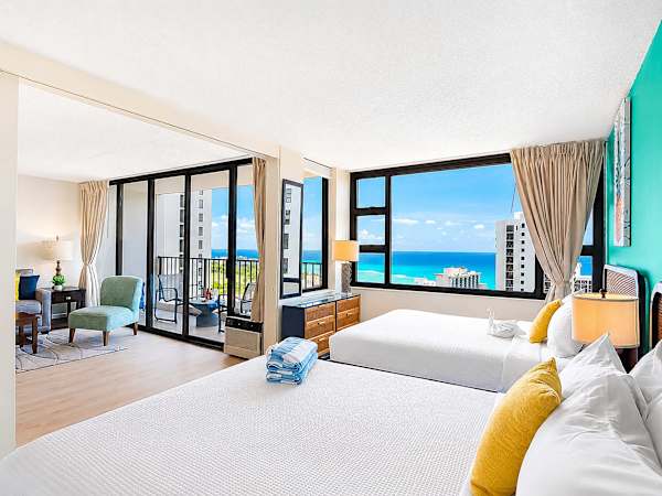 Bedroom with 2 Queen-size beds, nightstand, ocean view.