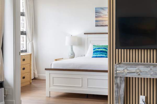 A sliding door separates the bedroom and the living area