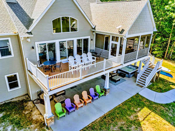 Rear Exterior - Dining on the main deck, a hot tub off to the side, and lake views from nearly every seat.