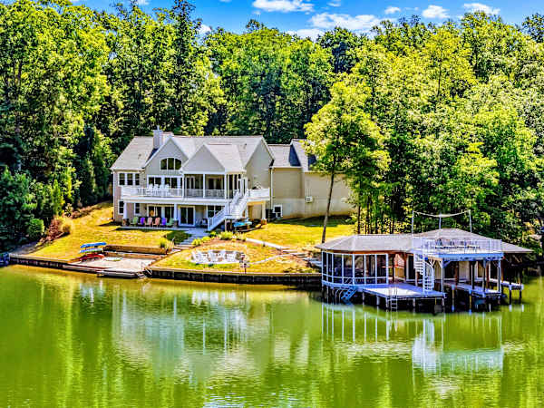 Aerial View - Lakefront from end to end, the home set back in the trees with its own dock and boathouse on the water.