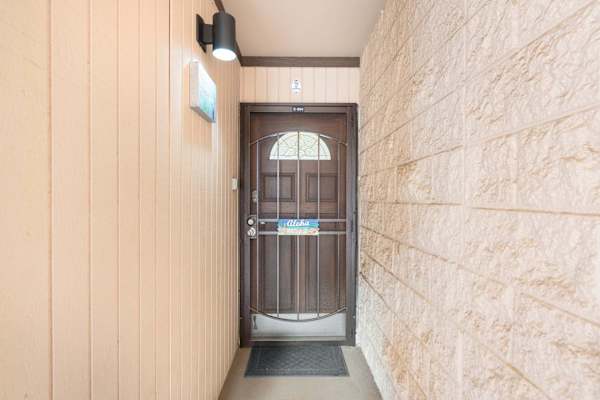Welcome home to your private tropical getaway, featuring a secure and inviting entry alcove