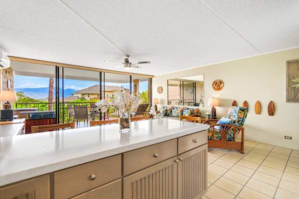 Look out across your spacious kitchen island to a bright, open living room and large sliding glass doors that open up to beautiful views.