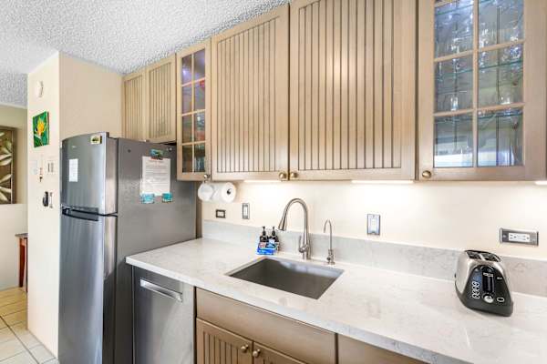 Enjoy the perfect blend of style and function in this sleek kitchen, featuring under-cabinet lighting, ample counter space, and a stainless steel dishwasher