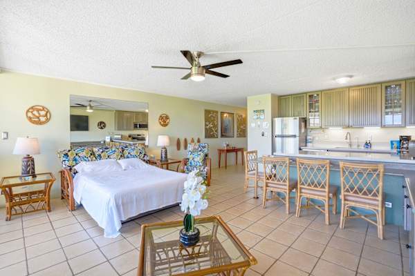 This open-concept living space perfectly connects the kitchen breakfast bar to a comfortable seating area, making entertaining a breeze.
