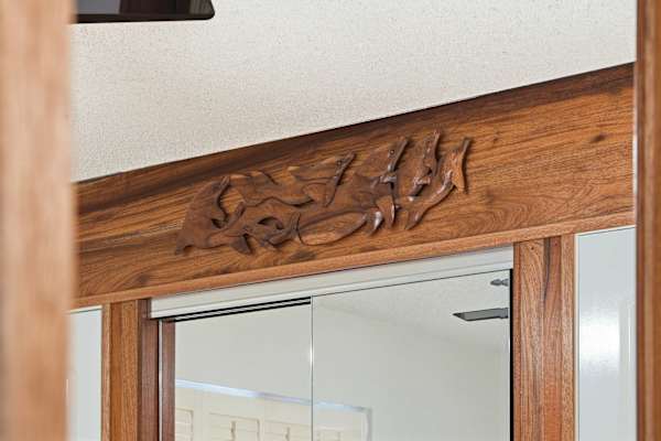 Appreciate the fine craftsmanship of the space with this exquisite, custom wood-carving detail framing the closet