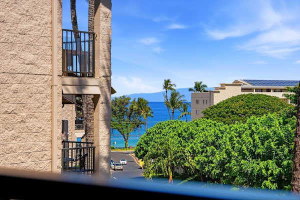 Take in the beautiful contrast of lush tropical palms and a stunning slice of the deep blue ocean from your balcony