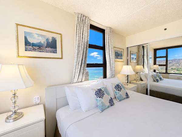Relax in your cozy bedroom, where large mirrored closets expand the space and a bedside window frames beautiful ocean glimpses