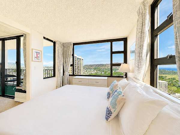 Experience the ultimate island escape with panoramic corner views of Diamond Head and the ocean straight from your plush king bed