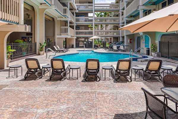 Spacious pool deck with lounge seating for relaxing in the sun.
