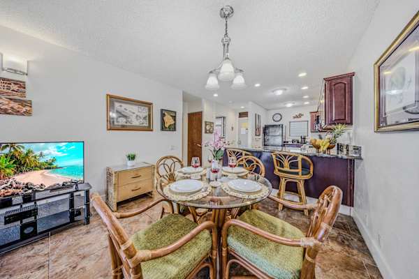 Fully set dining table and chairs in a bright, open-concept layout. 🍽️